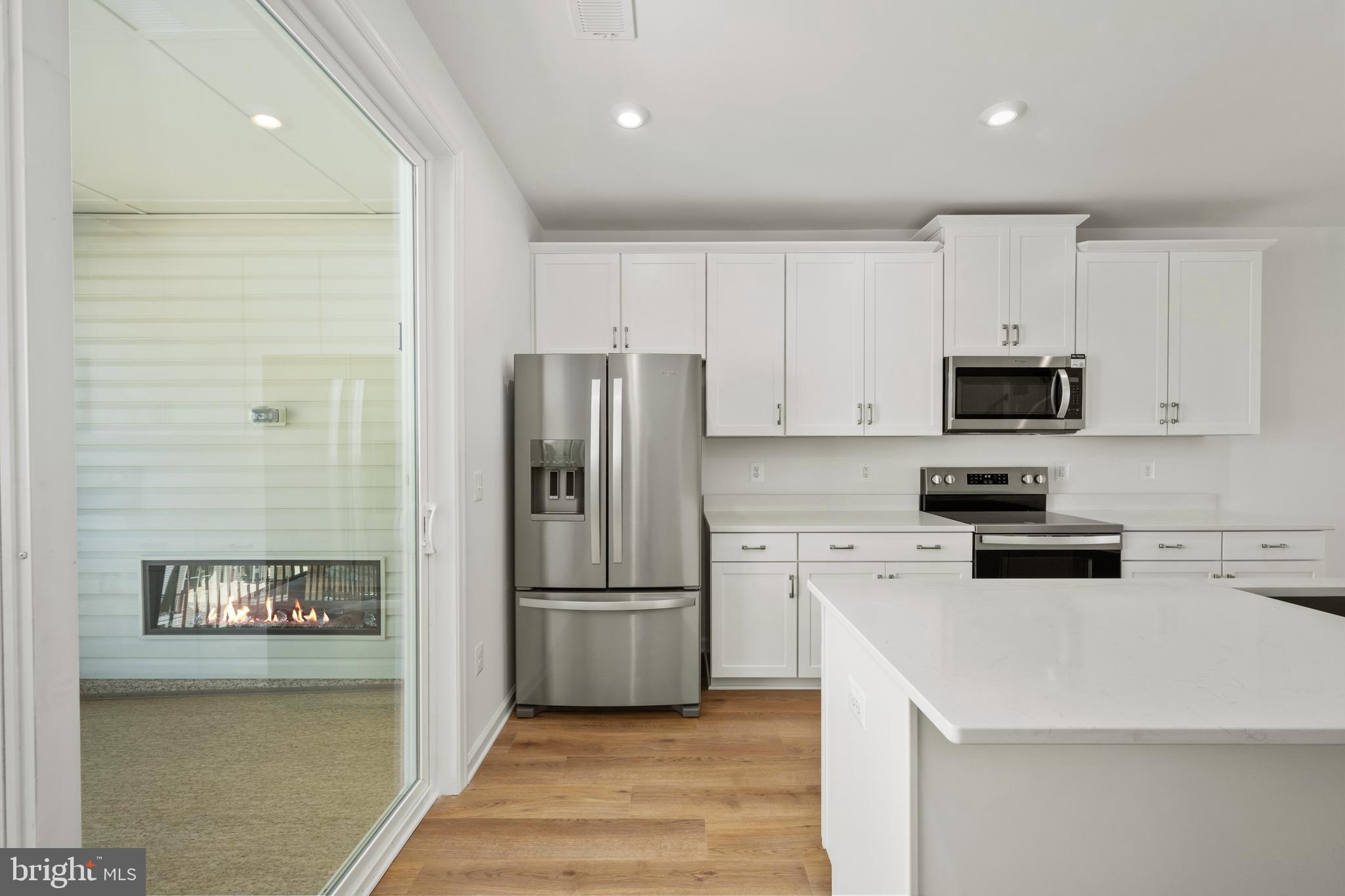 2518 Neabsco Common Place Woodbridge, VA 22191 - Photo 6 of 37 a kitchen with cabinets stainless steel appliances and a counter space