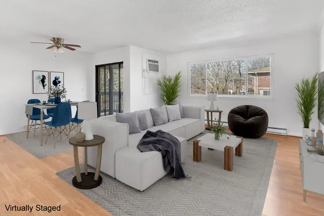a living room with fireplace furniture and a large window