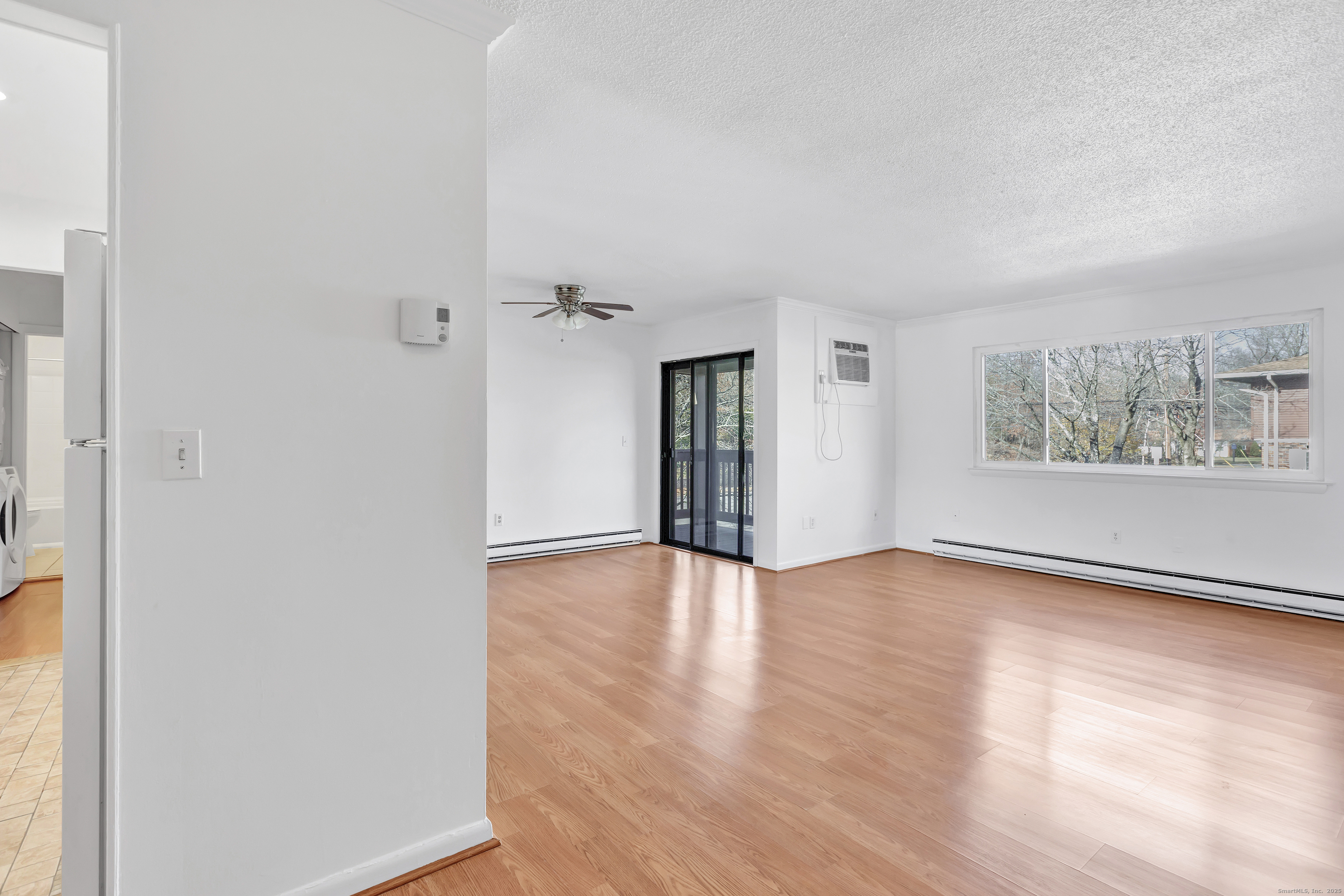3012 Madison Avenue, Unit F Bridgeport, CT 06606 - Photo 13 of 18 a view of an empty room with wooden floor and a window