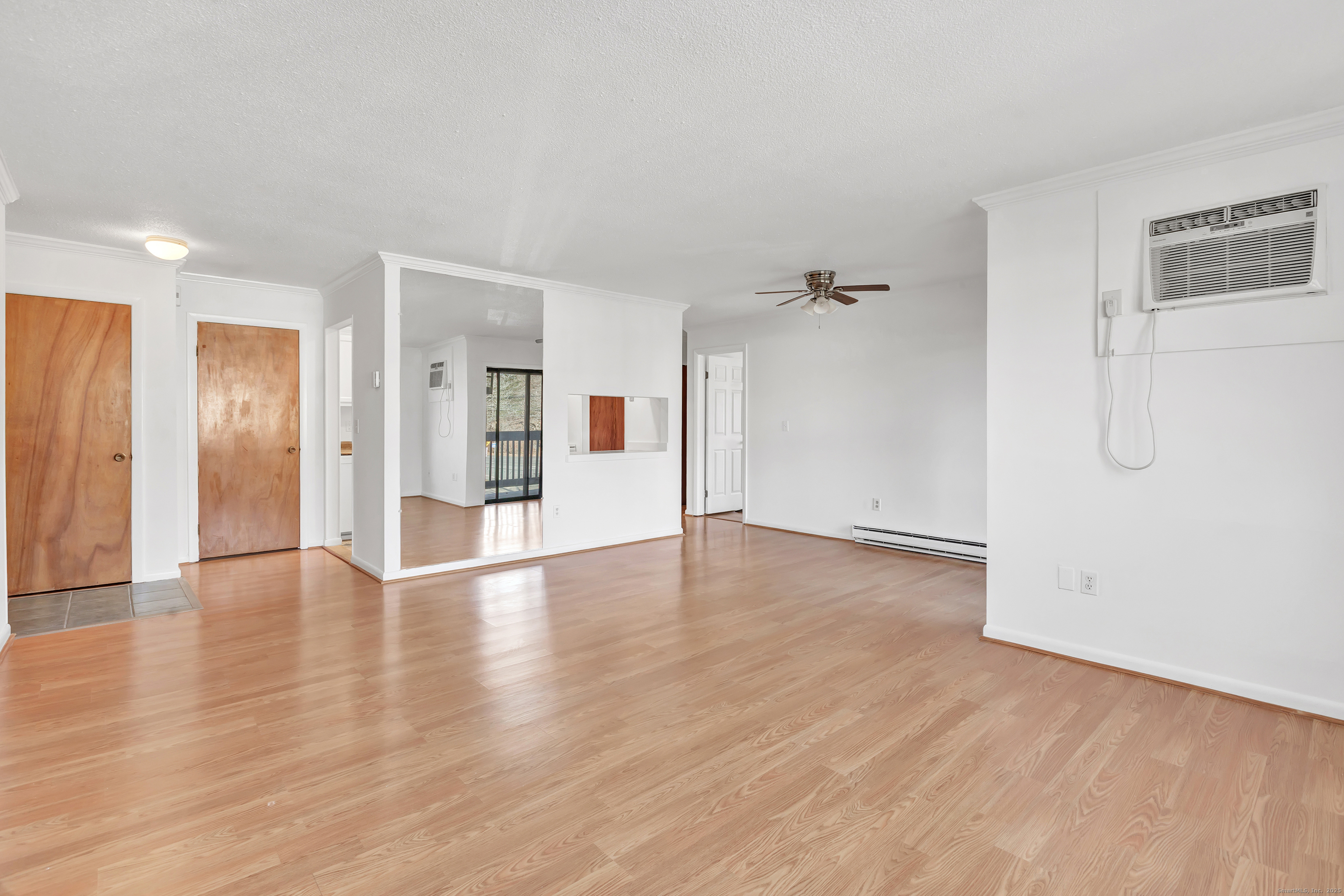 3012 Madison Avenue, Unit F Bridgeport, CT 06606 - Photo 15 of 18 a view of a big room with wooden floor and windows