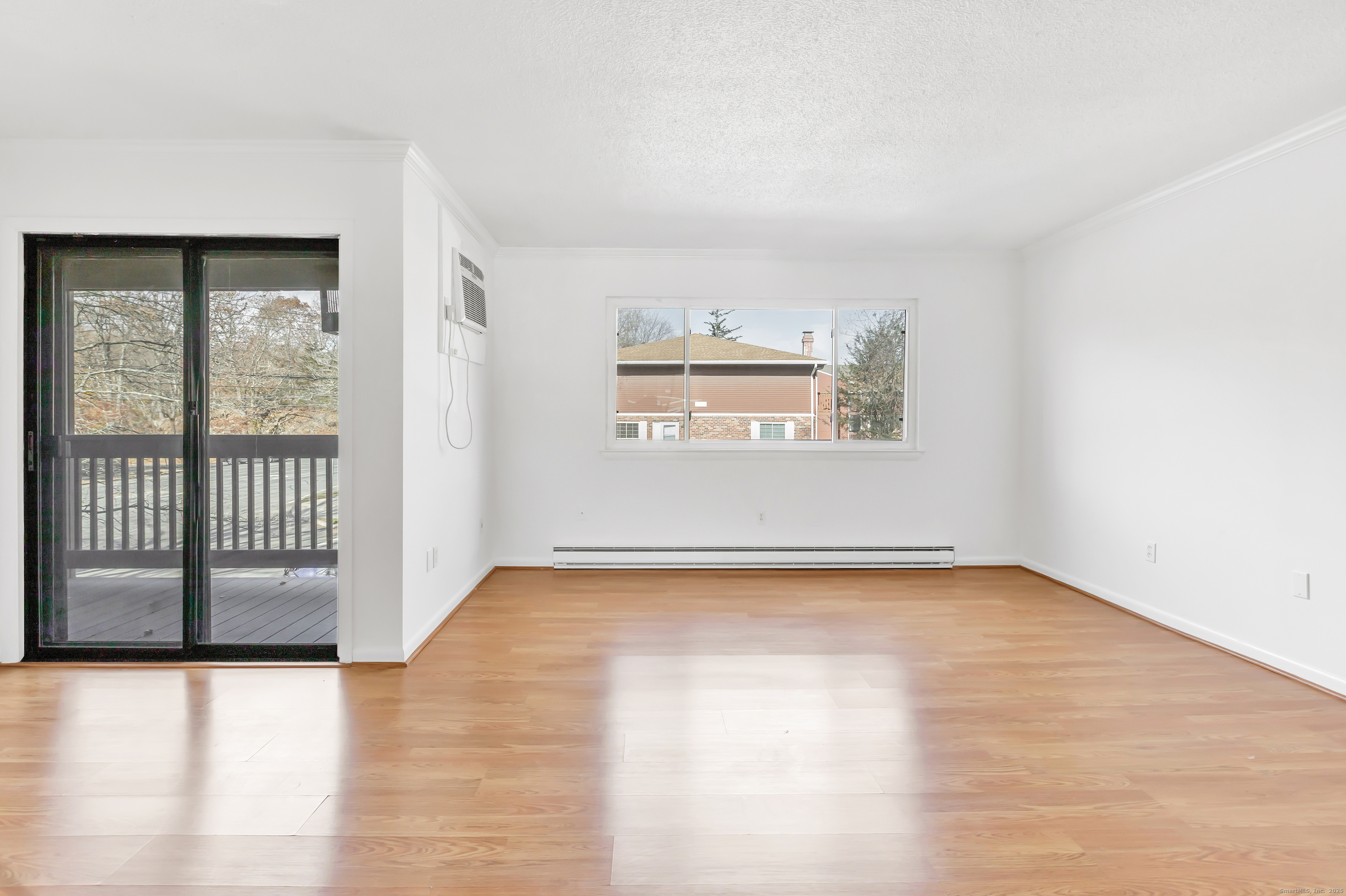3012 Madison Avenue, Unit F Bridgeport, CT 06606 - Photo 17 of 18 a view of a livingroom with wooden floor and a window