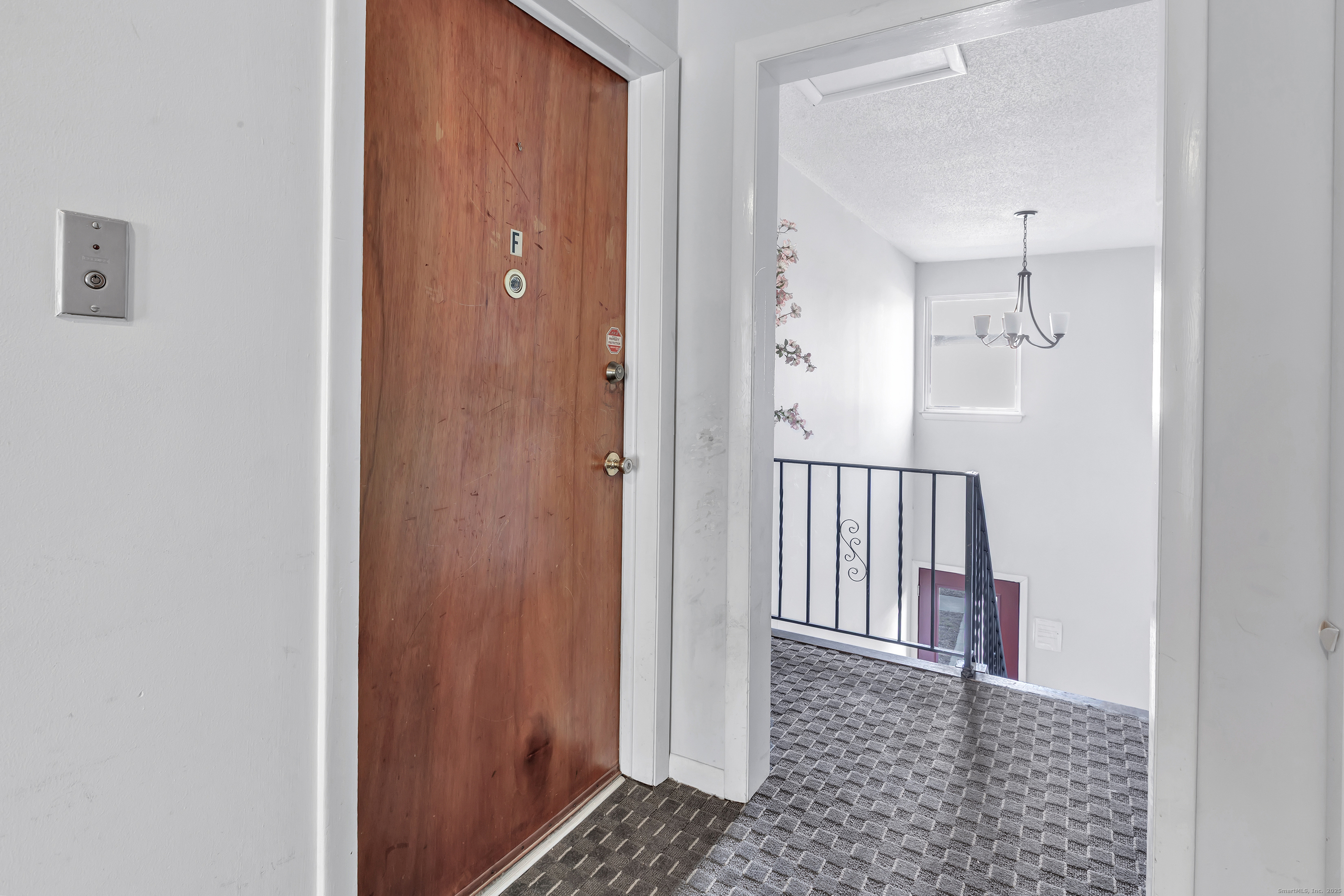 3012 Madison Avenue, Unit F Bridgeport, CT 06606 - Photo 10 of 18 a view of a hallway with wooden floor and a bathroom