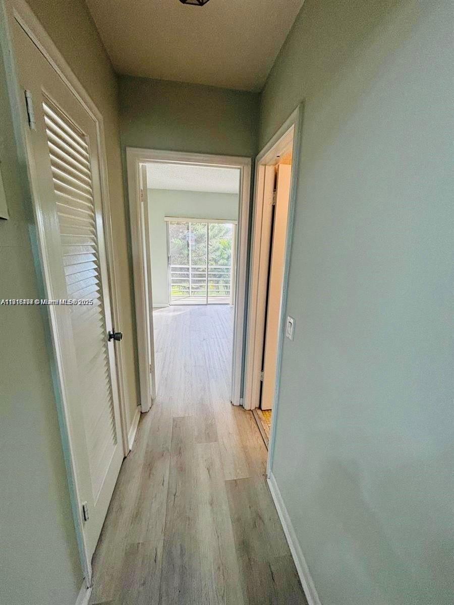 119 Salisbury East, Unit E West Palm Beach, FL 33417 - Photo 6 of 11 a view of a room with wooden floor and staircase