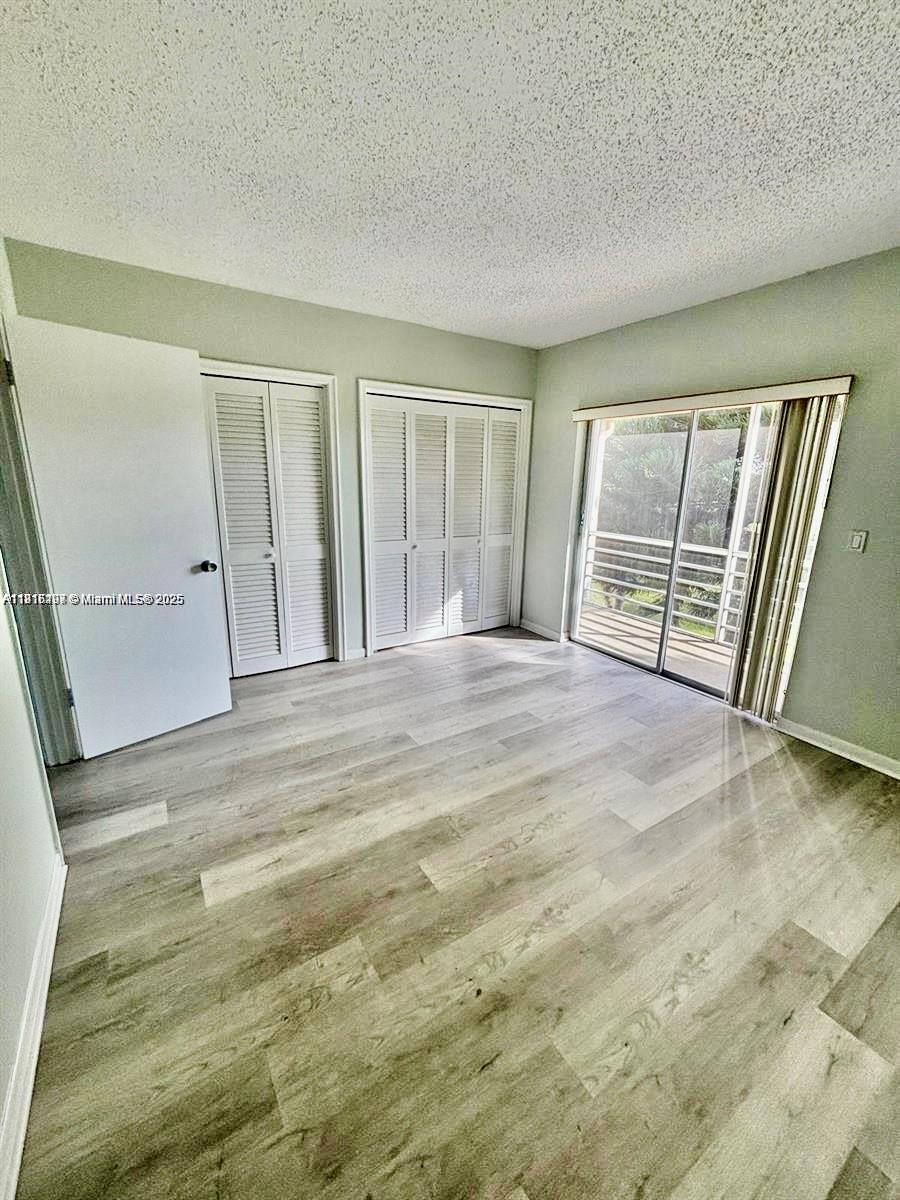 119 Salisbury East, Unit E West Palm Beach, FL 33417 - Photo 10 of 11 a view of an empty room with a fireplace and a window