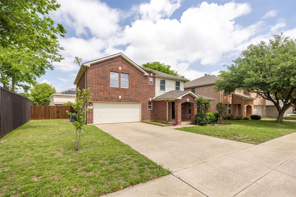 601 Amy Way Euless, TX 76039 - Photo 2 of 40 a front view of a house with a yard and garage
