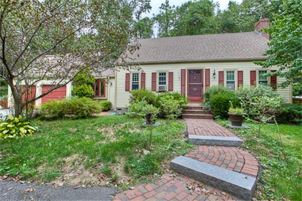 a aerial view of a house with yard and green space