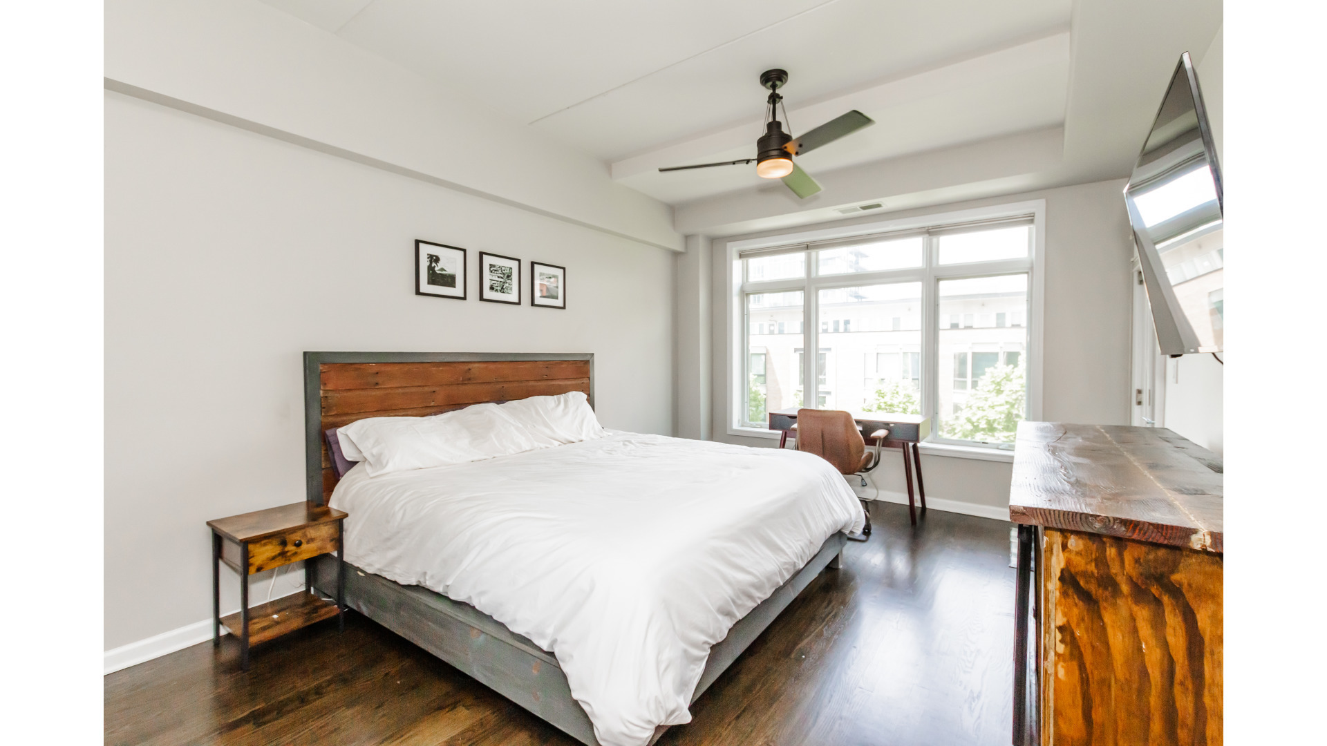 657 West Fulton Street, Unit 412 Chicago, IL 60661 - Photo 13 of 25 a bedroom with a bed and wooden floor