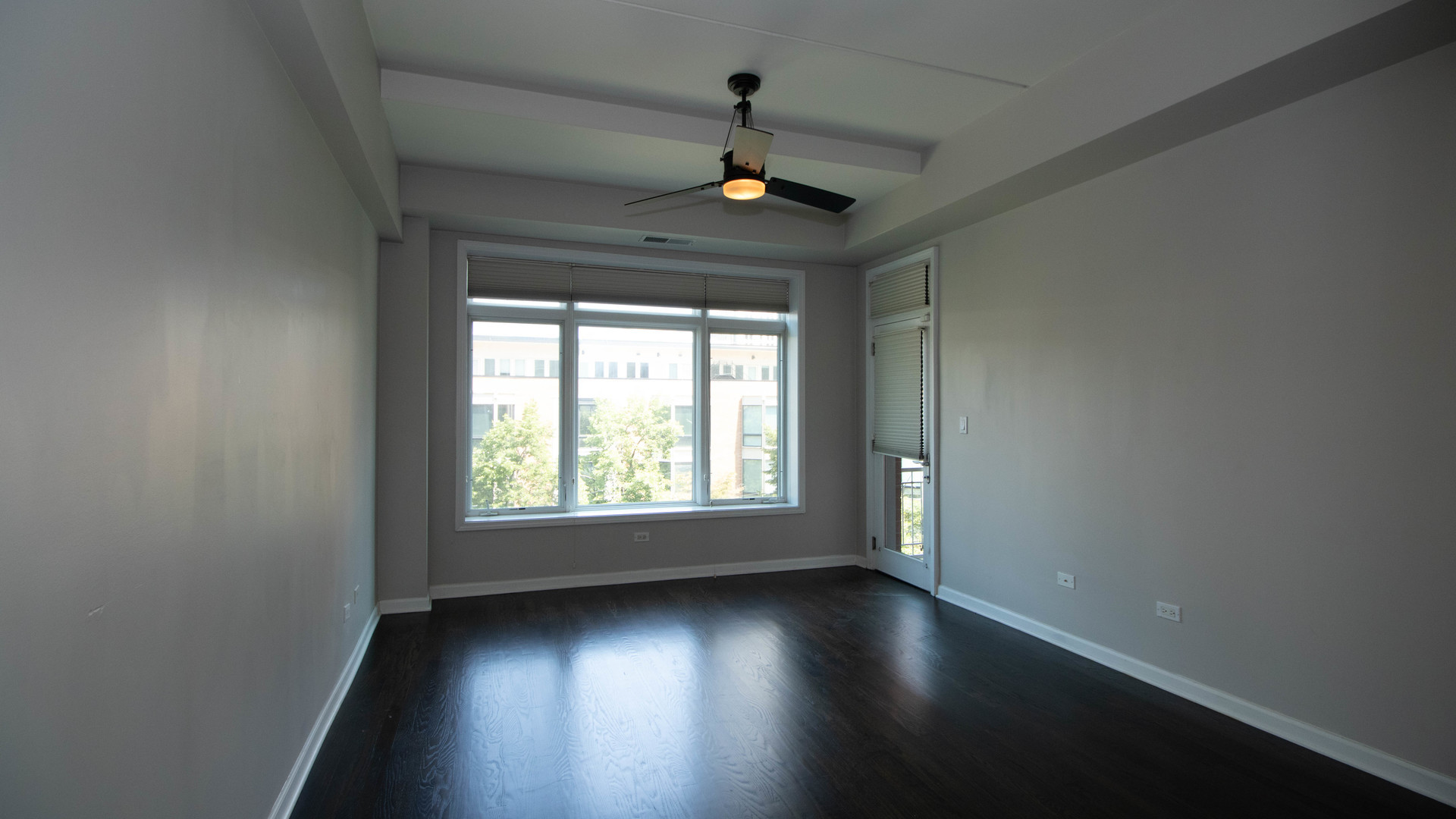 657 West Fulton Street, Unit 412 Chicago, IL 60661 - Photo 15 of 25 an empty room with wooden floor chandelier and windows