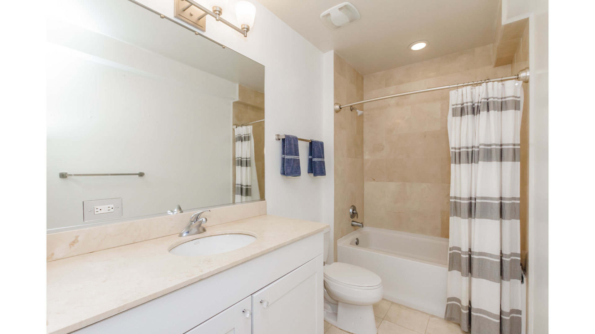 657 West Fulton Street, Unit 412 Chicago, IL 60661 - Photo 17 of 25 a bathroom with a granite countertop sink toilet mirror and shower