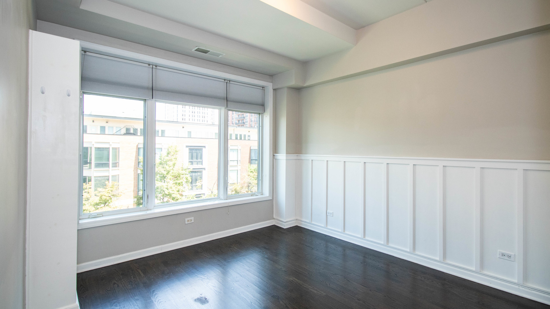 657 West Fulton Street, Unit 412 Chicago, IL 60661 - Photo 20 of 25 a view of an empty room with wooden floor and a window