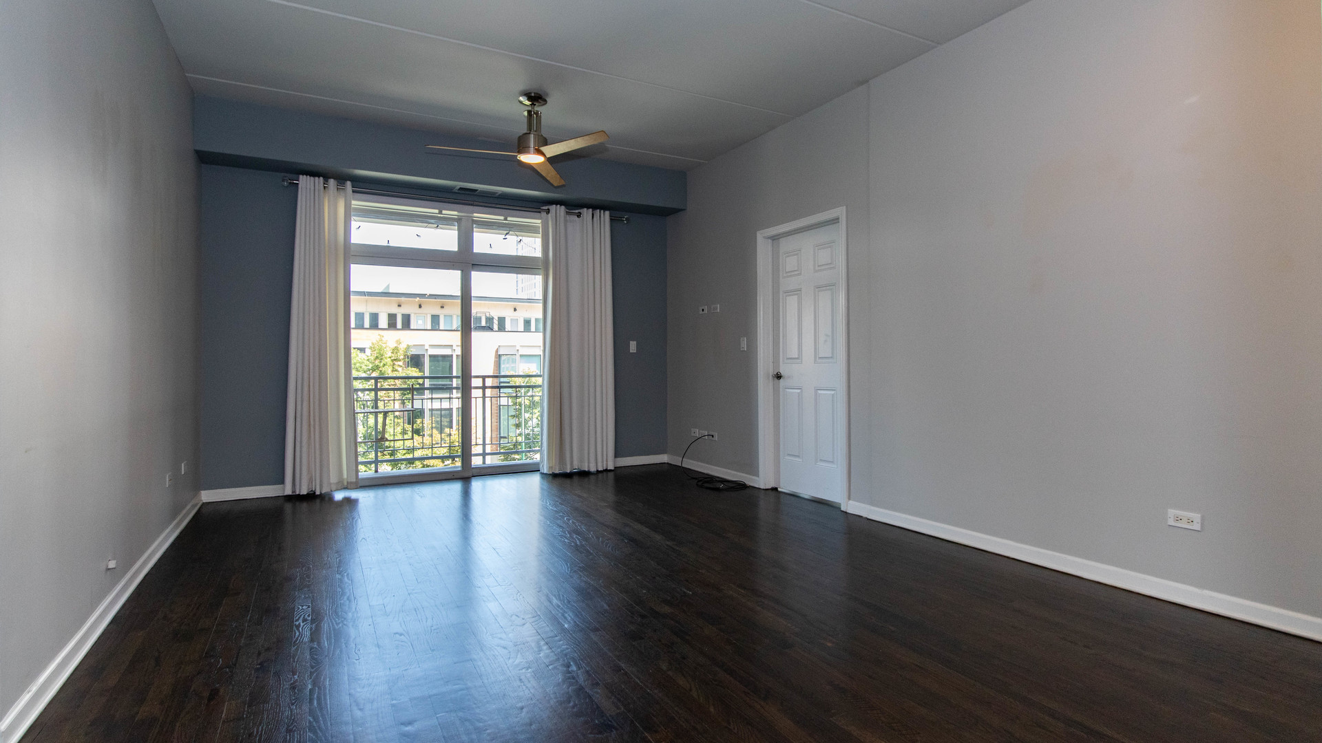 657 West Fulton Street, Unit 412 Chicago, IL 60661 - Photo 4 of 25 a view of an empty room with wooden floor and a window