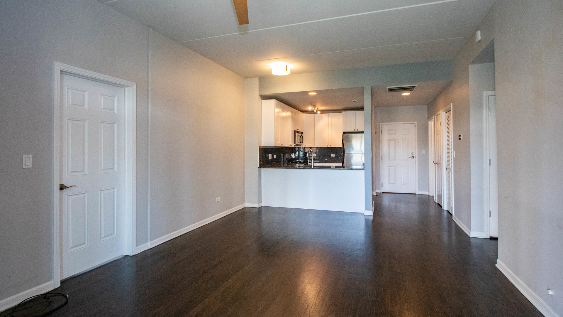 657 West Fulton Street, Unit 412 Chicago, IL 60661 - Photo 5 of 25 a view of a kitchen with wooden floor and a sink