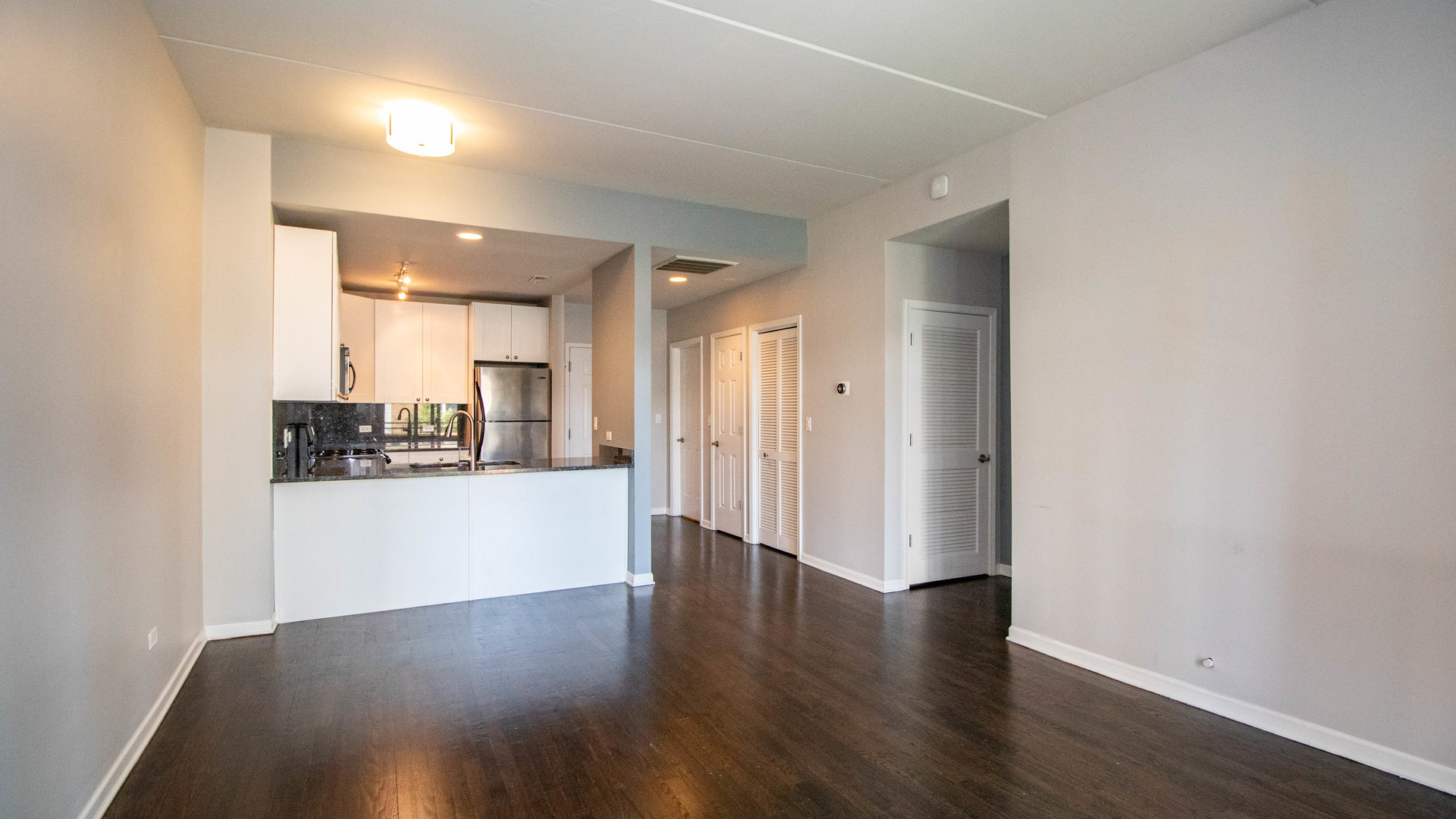 657 West Fulton Street, Unit 412 Chicago, IL 60661 - Photo 6 of 25 a view of a hallway with wooden floor and windows