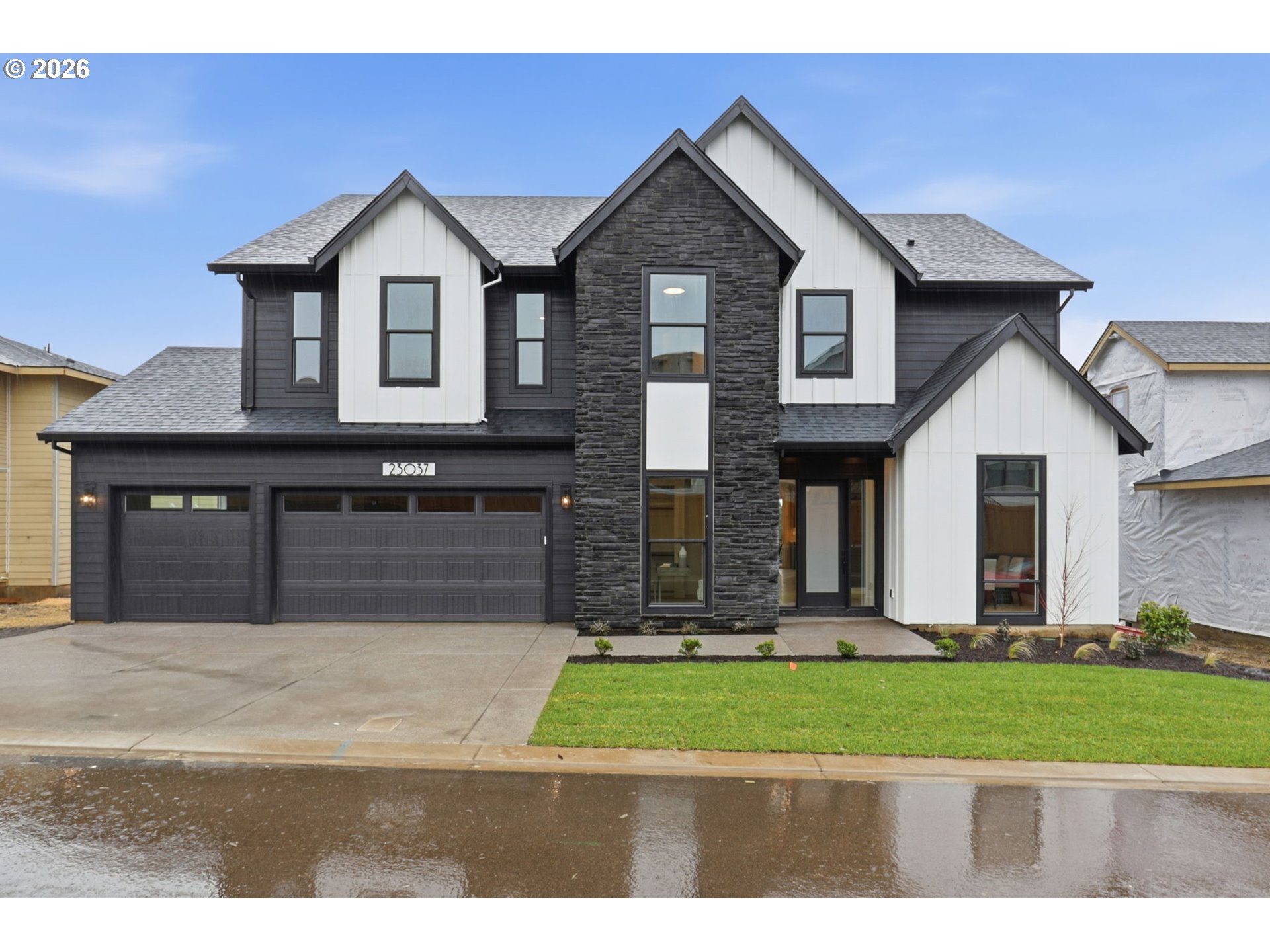 a front view of a house with a yard and garage
