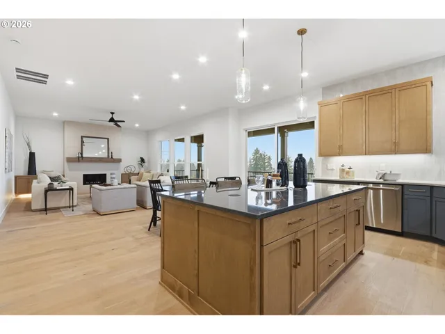 a kitchen with stainless steel appliances kitchen island granite countertop a sink and cabinets