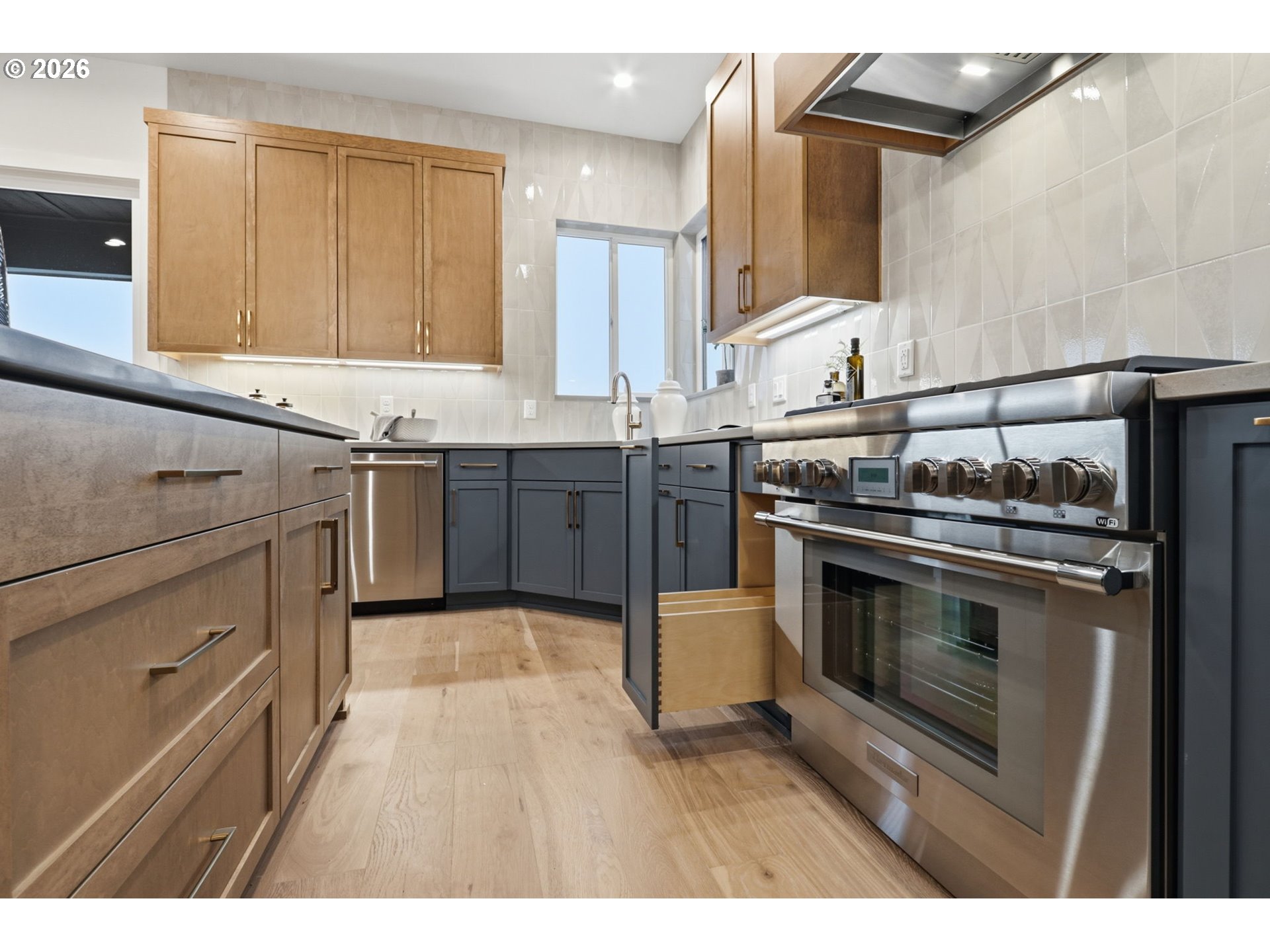 23037 Southwest Curry Rdg Drive Sherwood, OR 97140 - Photo 18 of 48 a kitchen with stainless steel appliances granite countertop a stove and a sink