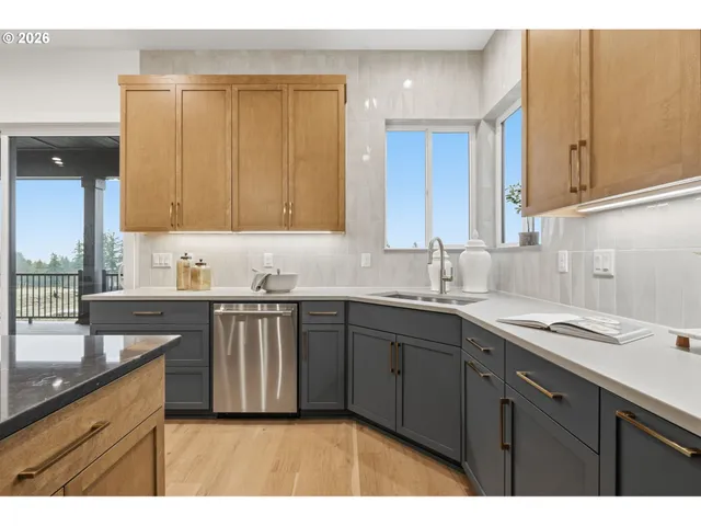 a kitchen with a sink cabinets and a window