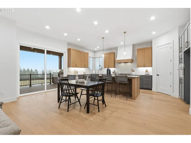 a open kitchen with kitchen island a sink table and chairs