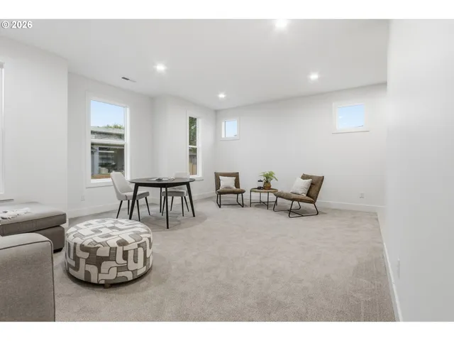 a living room with furniture and white walls