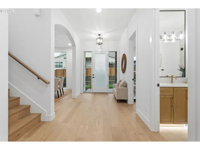 a hall way with furniture and wooden floor