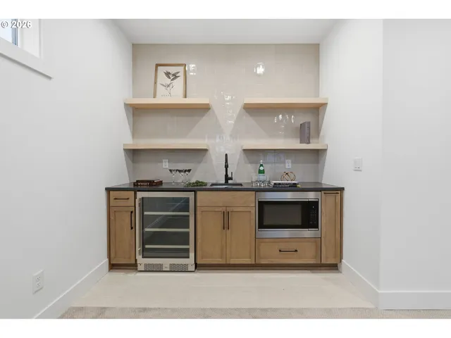 a kitchen with stainless steel appliances a stove and white cabinets