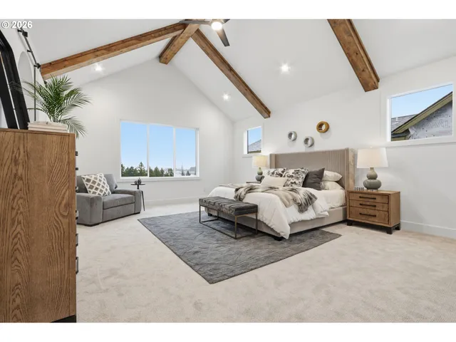 a bedroom with furniture and a large window