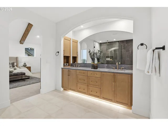 a bathroom with a sink a mirror and shower