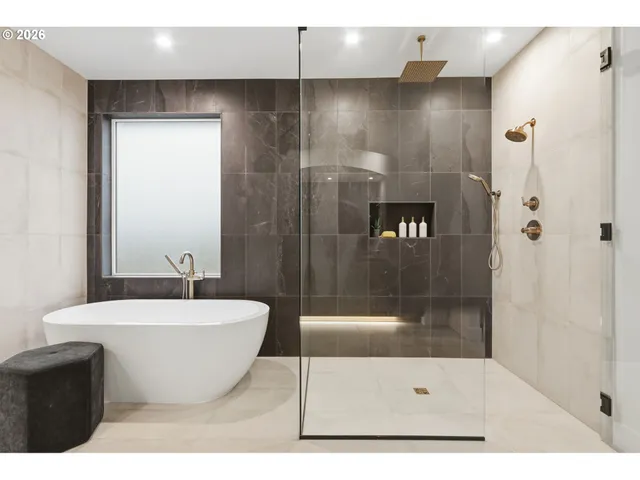 a bathroom with a bathtub and a shower