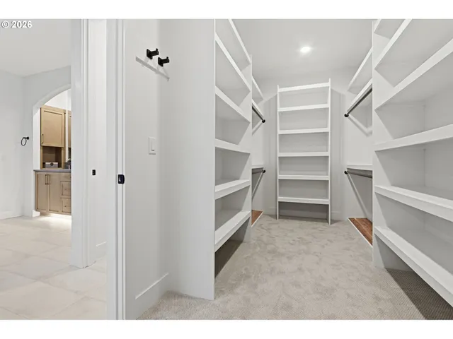 a view of walk in closet with empty racks