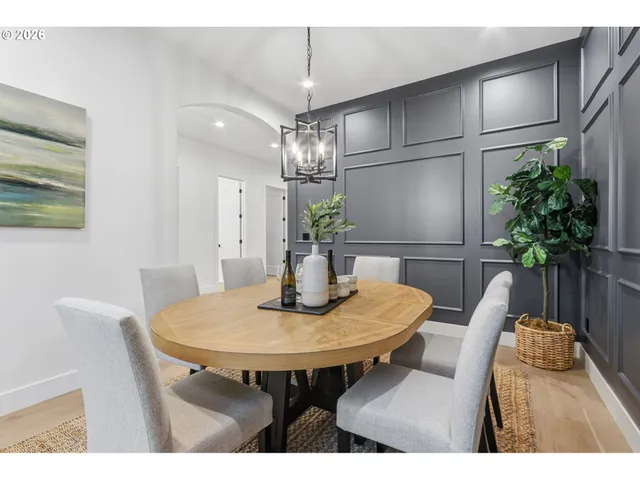 a dining room with furniture and wooden floor