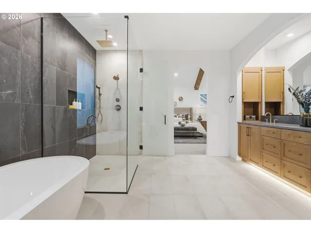 a bathroom with a tub a sink and mirrors