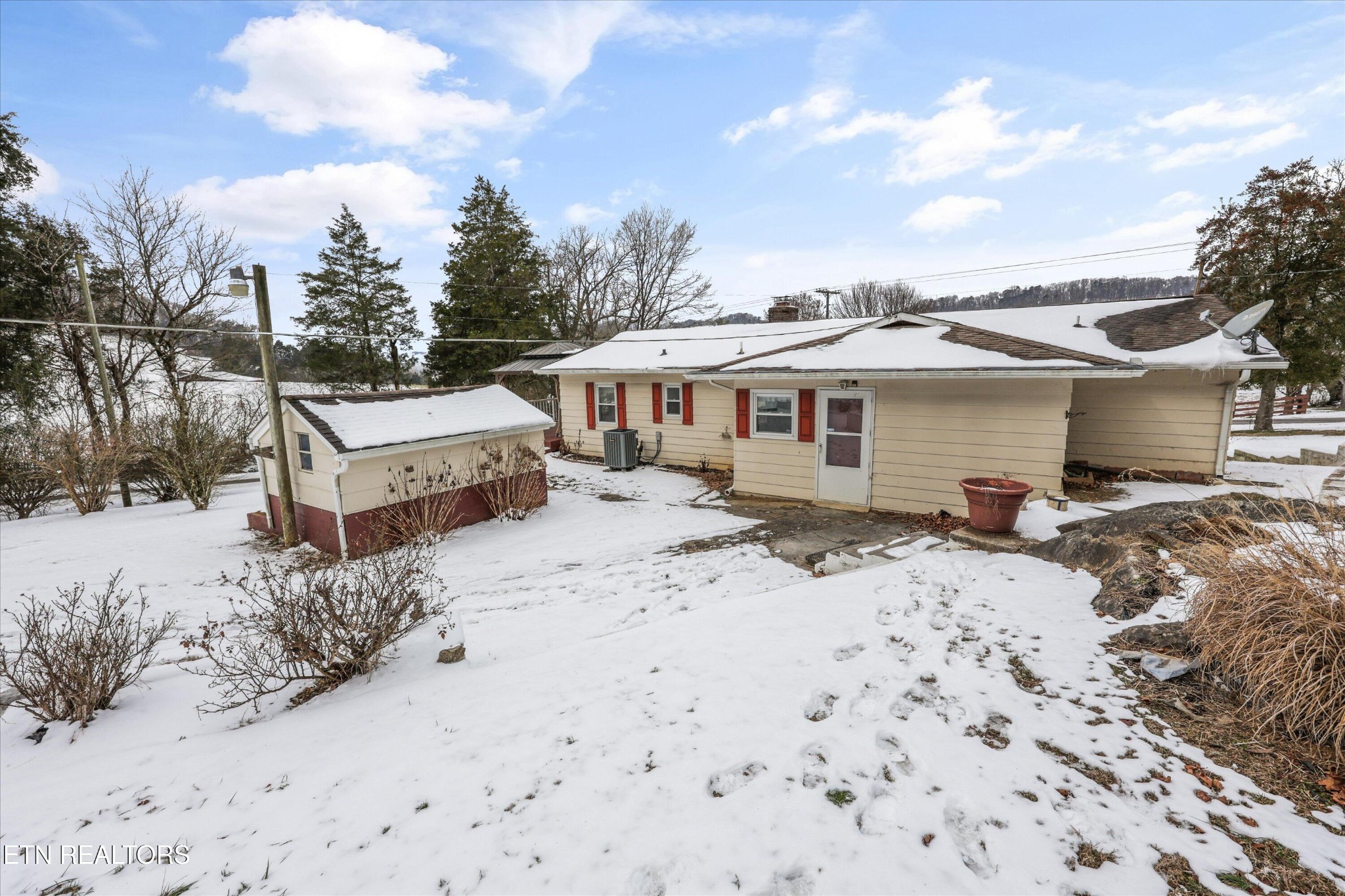 359 East Wolf Valley Road Heiskell, TN 37754 - Photo 19 of 40 a front view of a house with a yard covered in snow