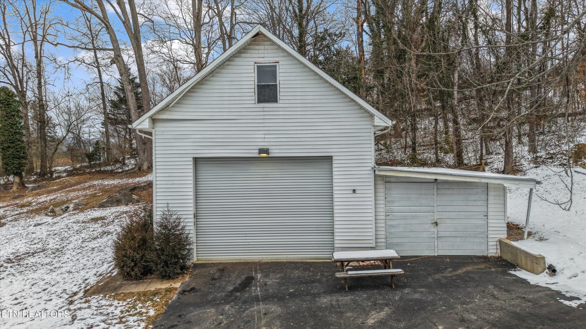 359 East Wolf Valley Road Heiskell, TN 37754 - Photo 23 of 40 a view of a small house with a garage