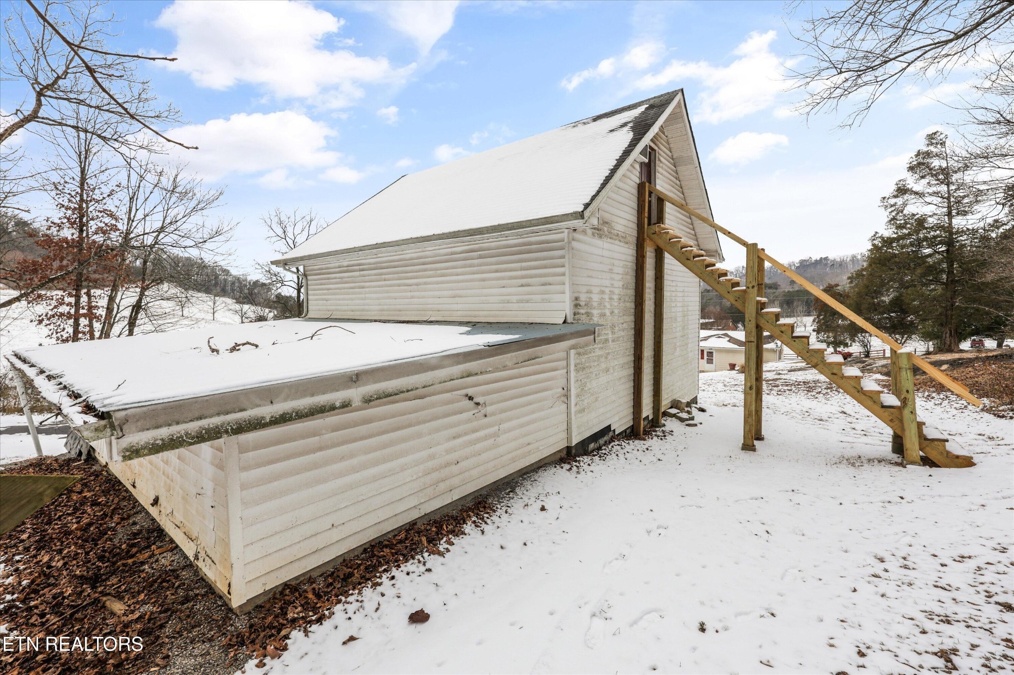 359 East Wolf Valley Road Heiskell, TN 37754 - Photo 26 of 40 a view of a house with a snow in the yard