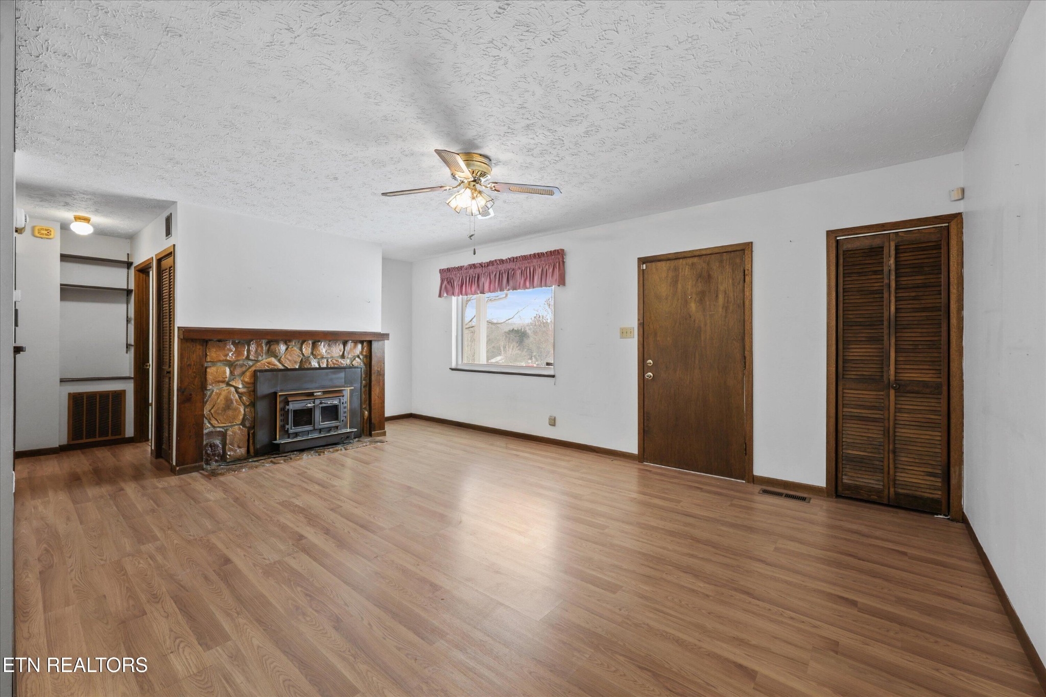 359 East Wolf Valley Road Heiskell, TN 37754 - Photo 5 of 40 an empty room with windows and fireplace