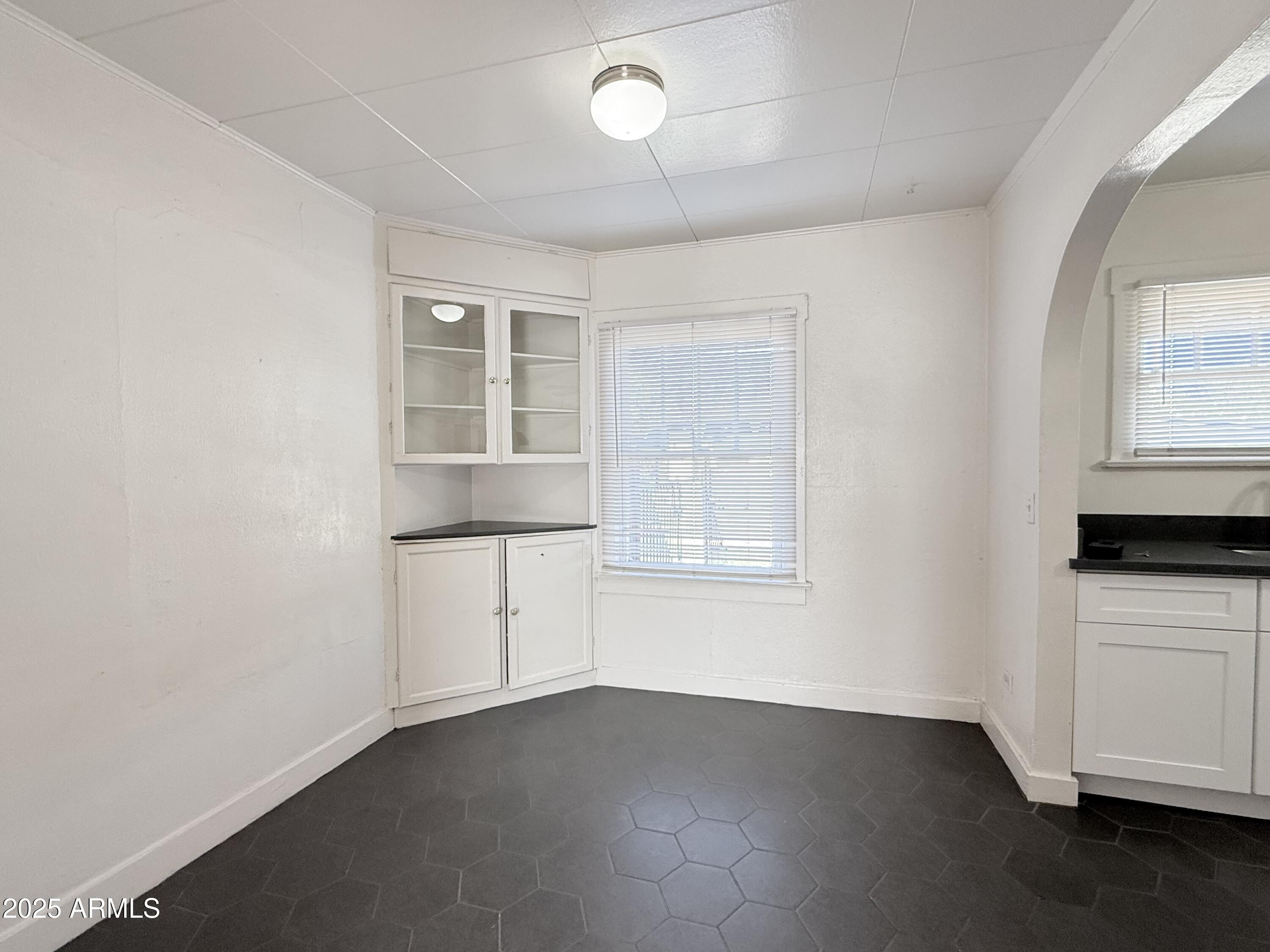 3809 North 9th Place Phoenix, AZ 85014 - Photo 11 of 28 an empty room with wooden floor and windows