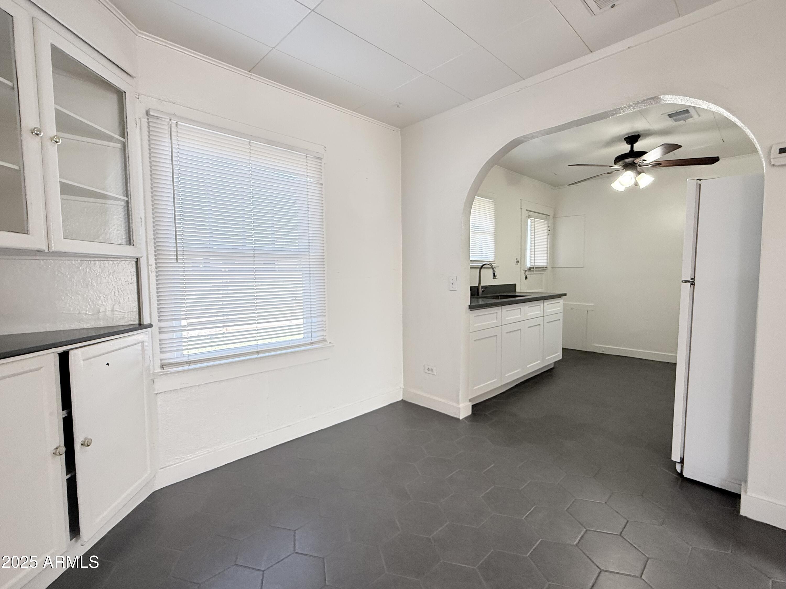 3809 North 9th Place Phoenix, AZ 85014 - Photo 12 of 28 a view of a kitchen with a sink and cabinet wooden floor windows