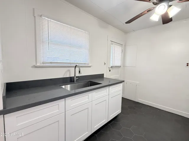 a kitchen with a sink and cabinets