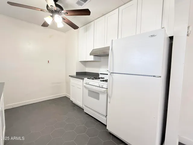 a white refrigerator freezer sitting inside of a kitchen