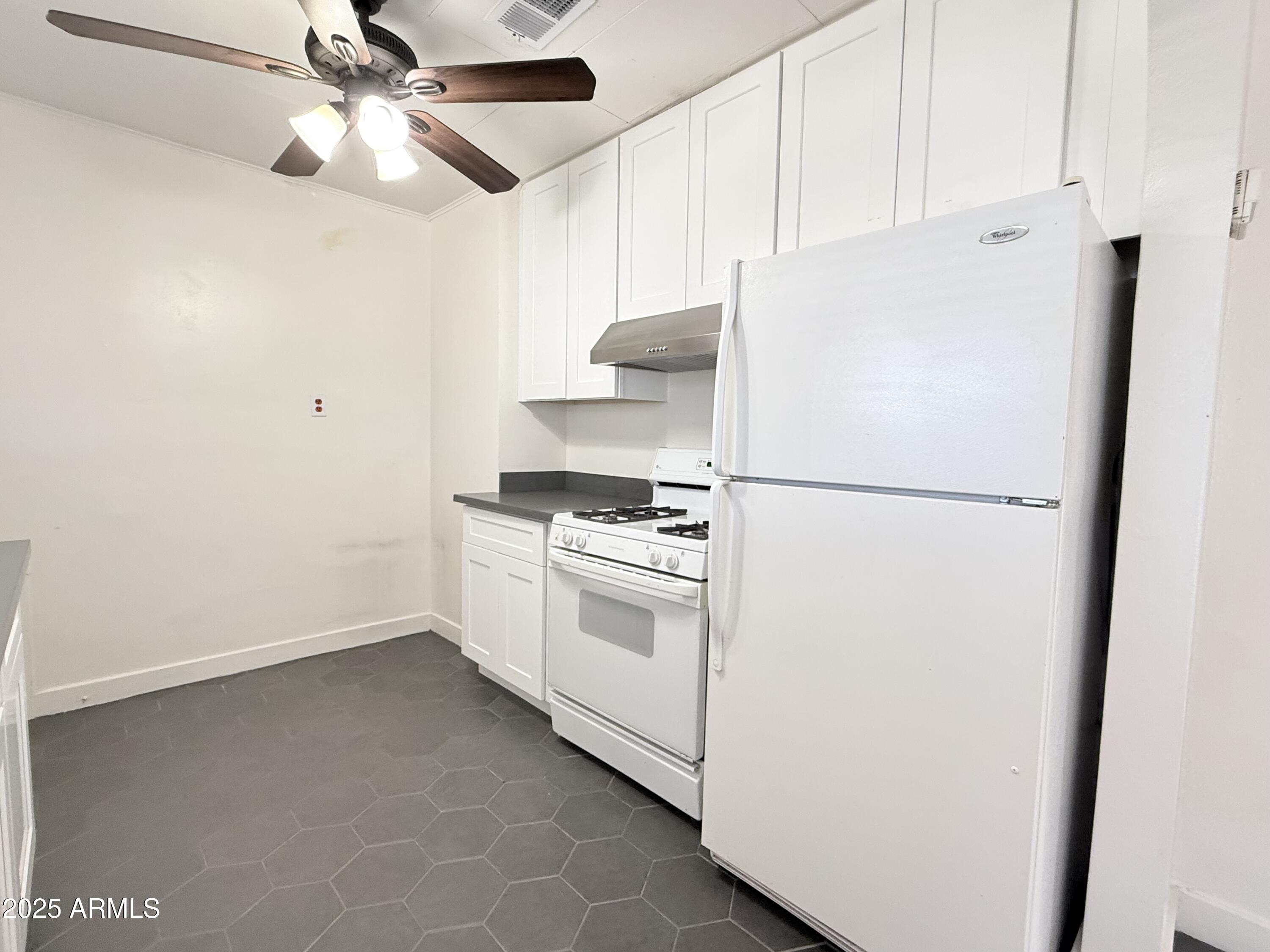 3809 North 9th Place Phoenix, AZ 85014 - Photo 15 of 28 a white refrigerator freezer sitting inside of a kitchen