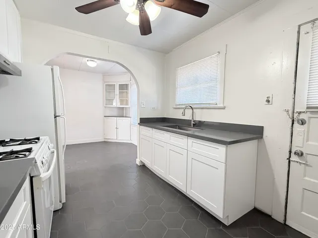 a kitchen with a sink and a refrigerator