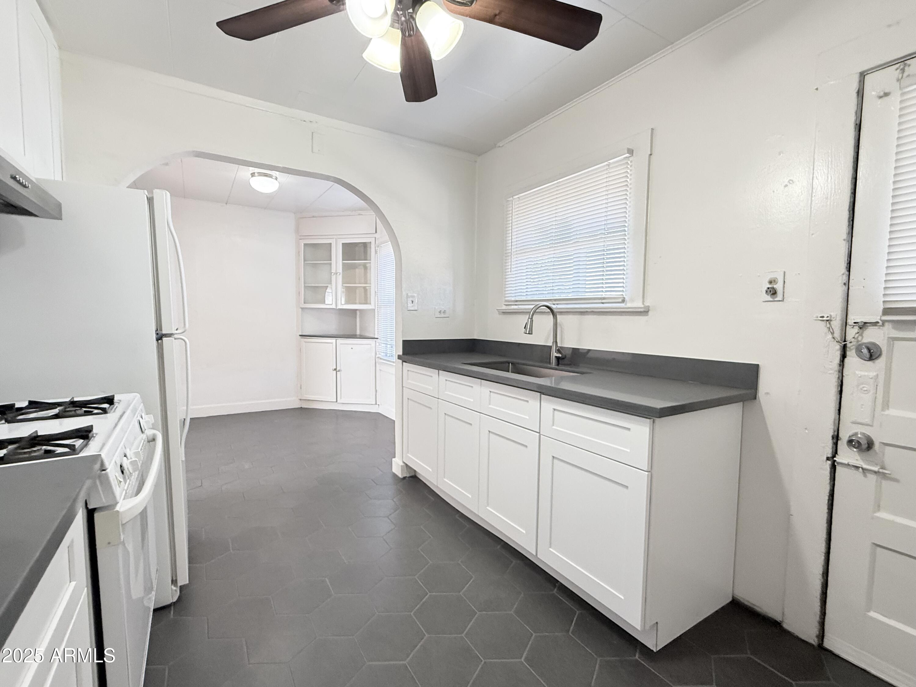 3809 North 9th Place Phoenix, AZ 85014 - Photo 17 of 28 a kitchen with a sink and a refrigerator