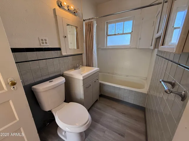 a bathroom with a toilet a sink and a mirror