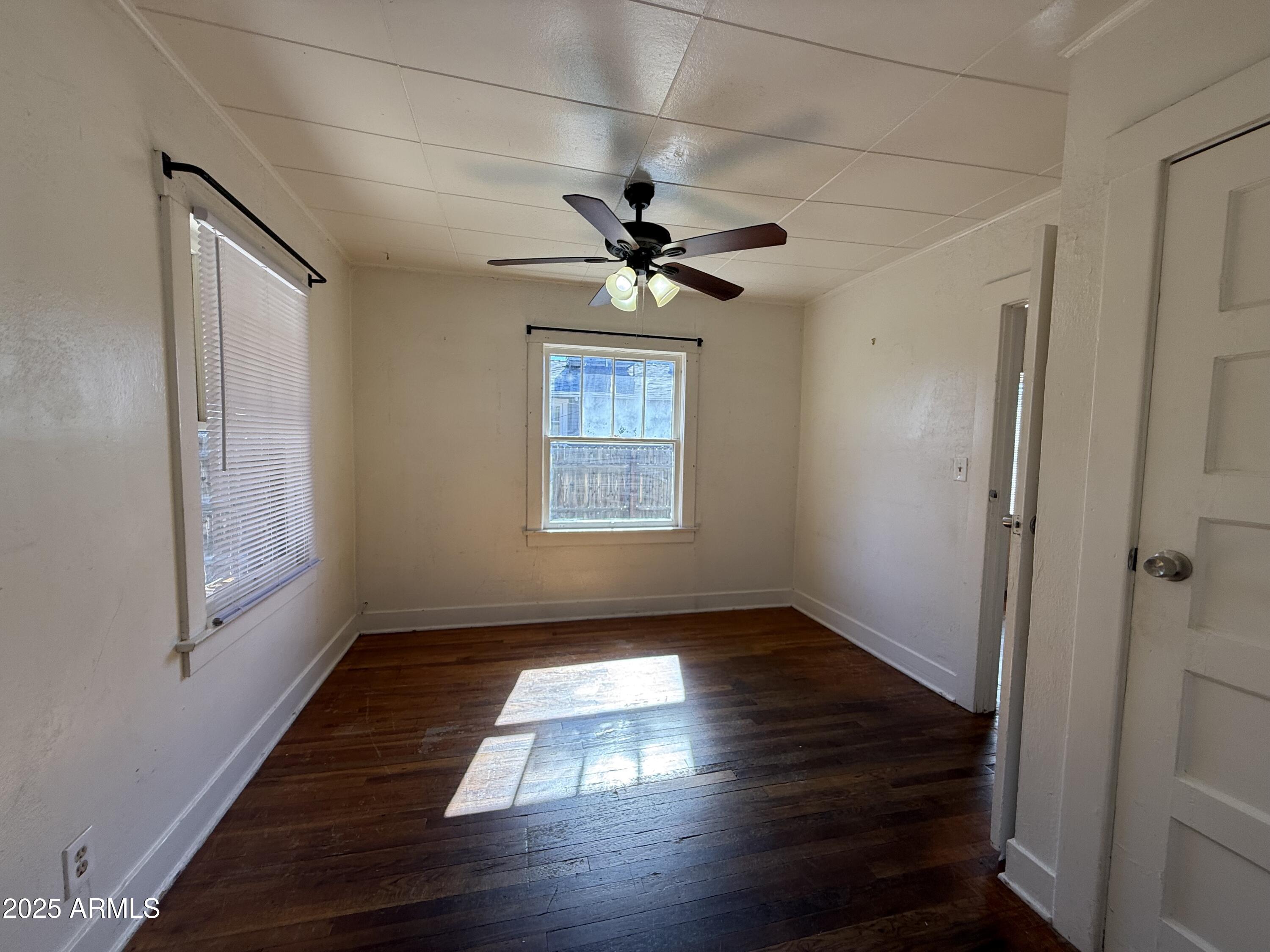 3809 North 9th Place Phoenix, AZ 85014 - Photo 22 of 28 wooden floor in an empty room with a window
