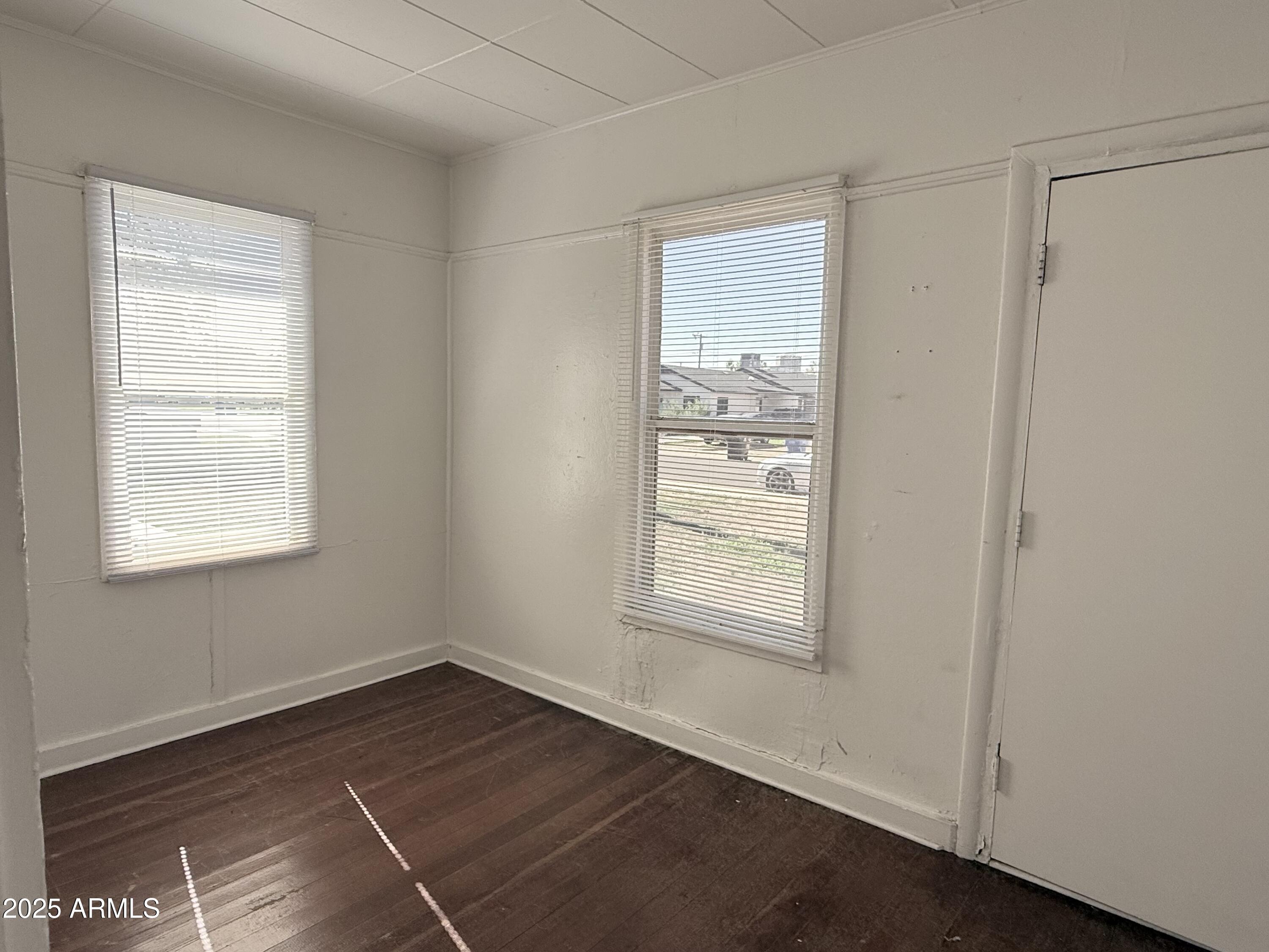 3809 North 9th Place Phoenix, AZ 85014 - Photo 5 of 28 an empty room with wooden floor and windows