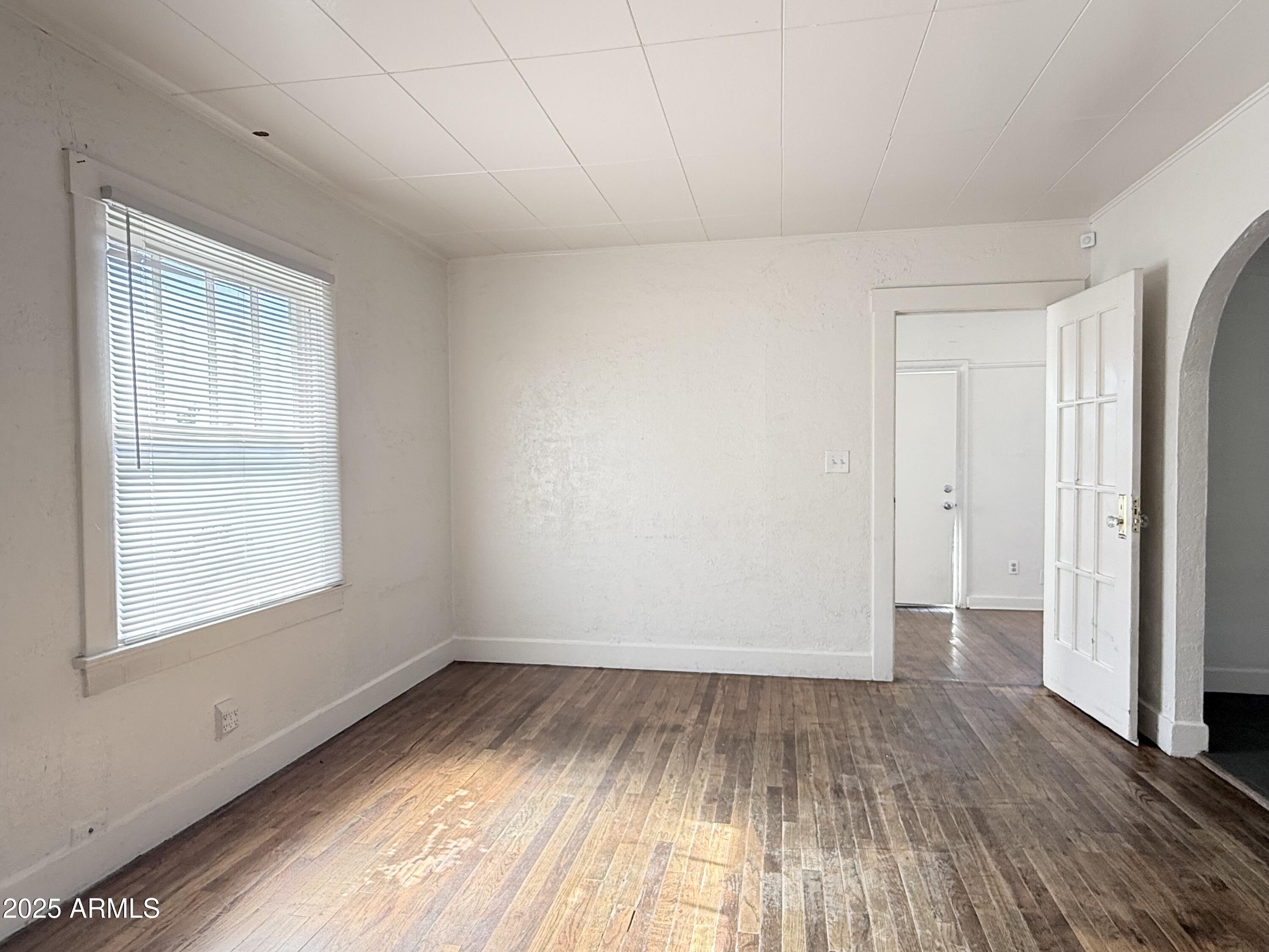 3809 North 9th Place Phoenix, AZ 85014 - Photo 8 of 28 wooden floor in an empty room with a window