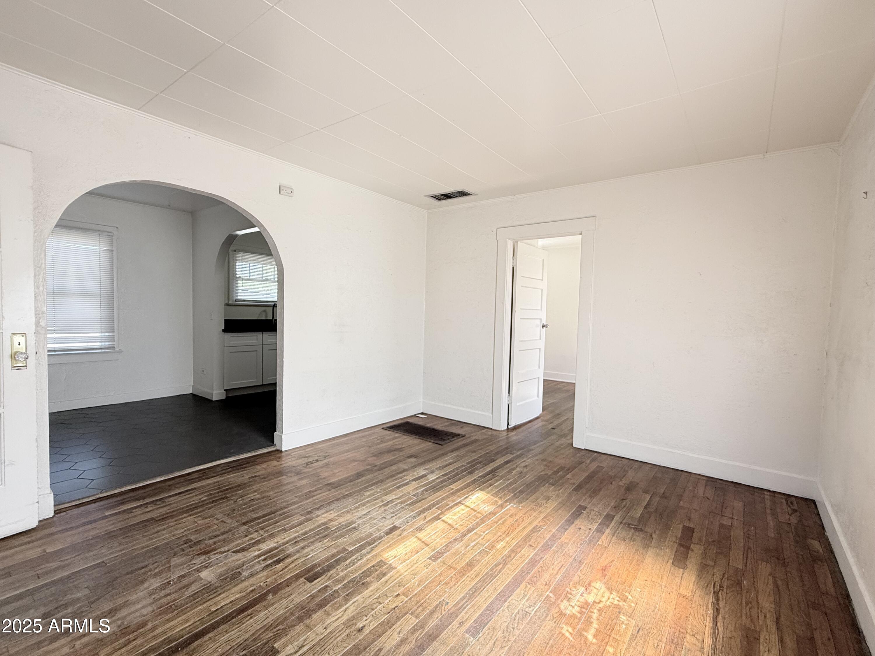 3809 North 9th Place Phoenix, AZ 85014 - Photo 10 of 28 a view of empty room with wooden floor