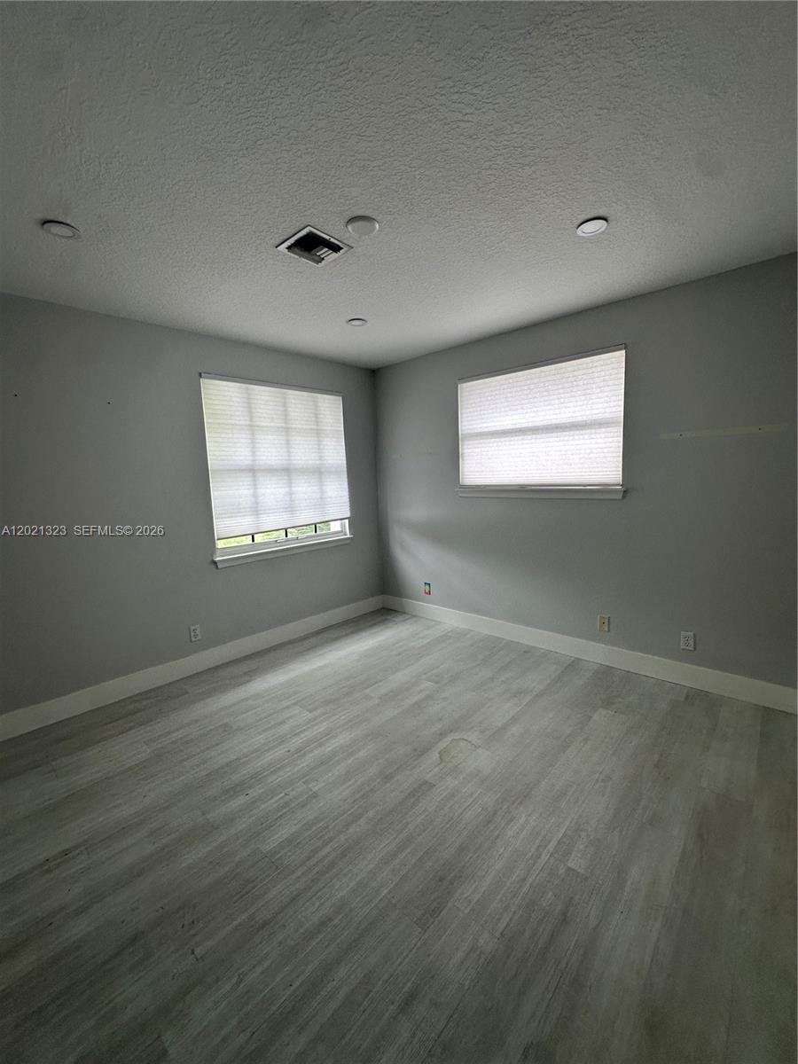 354 Mallard Road, Unit O Weston, FL 33327 - Photo 16 of 29 an empty room with wooden floor and windows