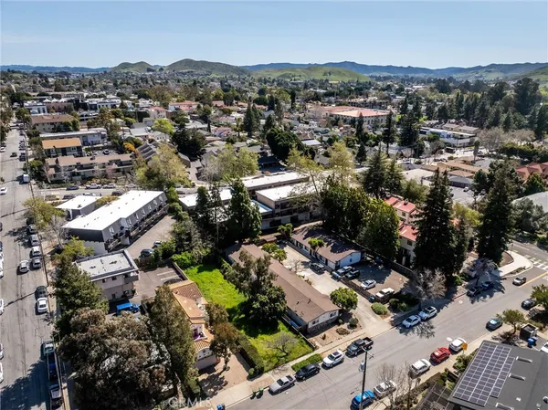 an aerial view of residential houses with outdoor space