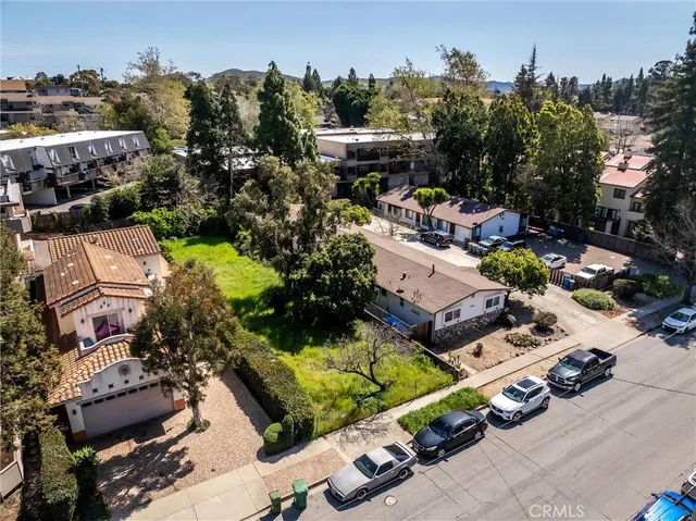 an aerial view of a house with a garden and lake view